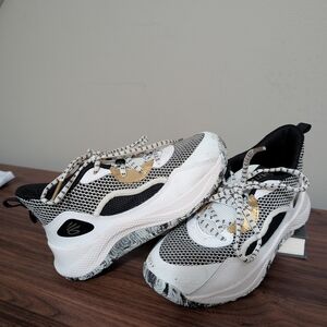 Under Armour Women's Sneakers in White, Black, and Gold